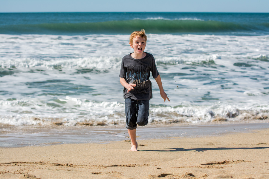 Male child running on Half Moon Beach photo