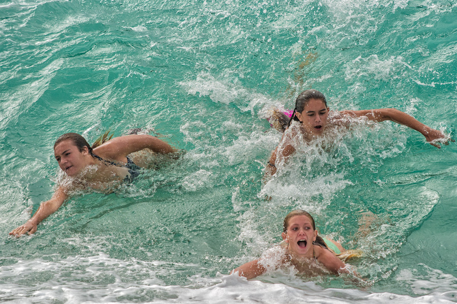 Three girls bodysurfing in Hawaii photo