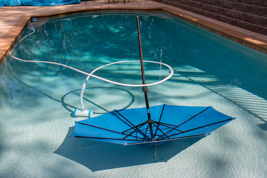 Blue cabana umbrella at bottom of pool photo